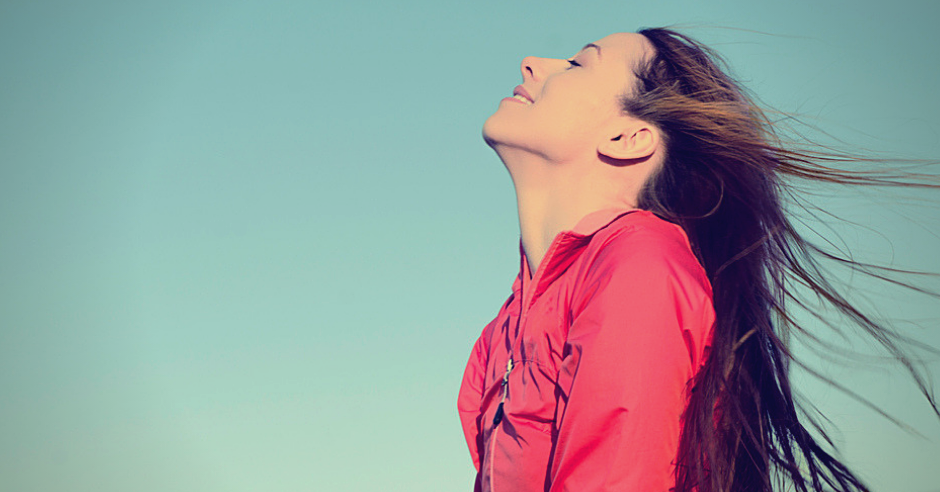 Woman smiling looking up to blue sky taking deep breath celebrating freedom. Positive human emotion face expression feeling life perception success peace mind concept. Free Happy girl enjoying nature